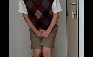 Uniformed schoolboy with dunce cap is desperate to pee in time out