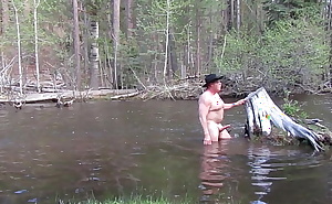 Naked bathing in the river.