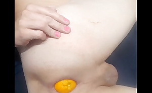 Huge orange in ass pops out. Big gape