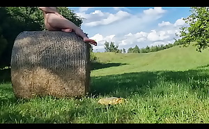 Jerking of outside on a hay bale with a cum in the end