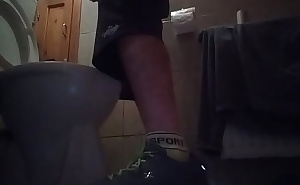 Sporty guy peeing at home