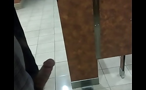 Jerking thick cock in public bathroom