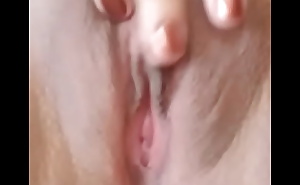 Touching her clitoris with her fingers