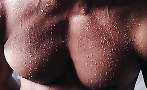 Close up into the sweat over flexing body